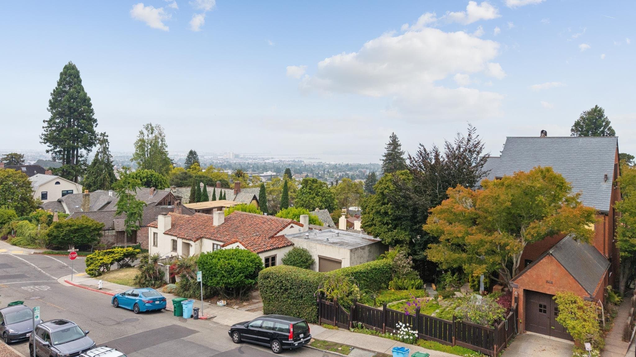 The outlook from Le Roy Avenue — rooftops and autumn trees, the Berkeley flats, and the Bay on the horizon